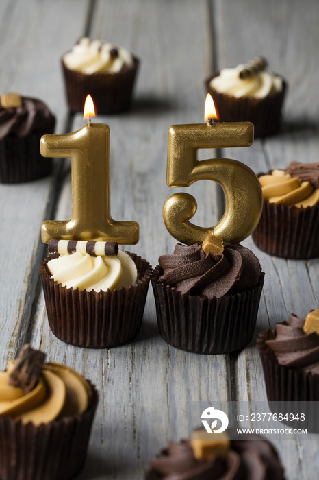 Number 15 celebration birthday cupcakes on a wooden background