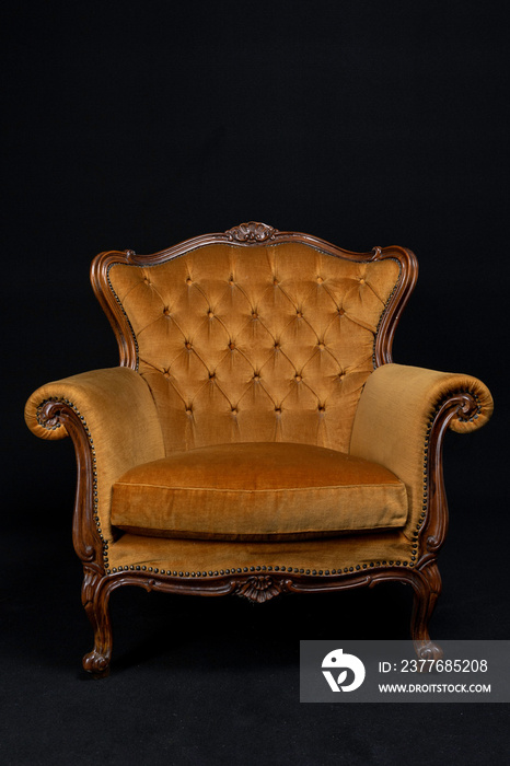 golden Isolated Bergère armchair on black background