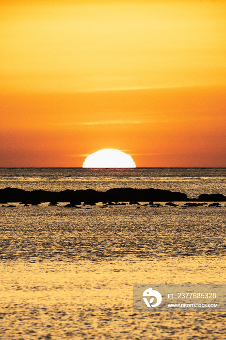 Sunset at Sanlúcar de Barrameda beach, Spain, with moored fishing boats.