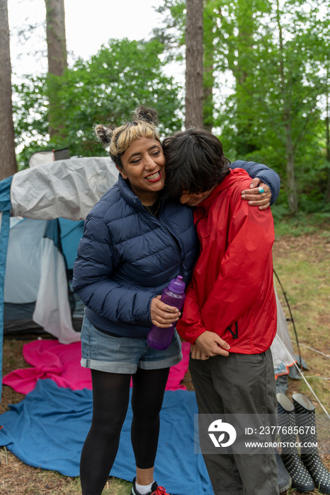 Mother and son camping in forest