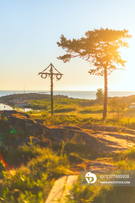 Midsummer pole at the coastline during early morning with a warm clear sky