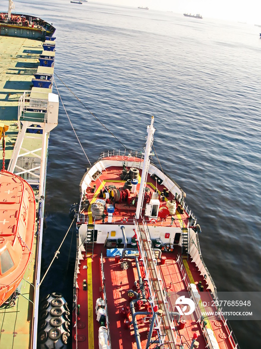 View of the bunker barge at the alongside of the vessel in the roads.