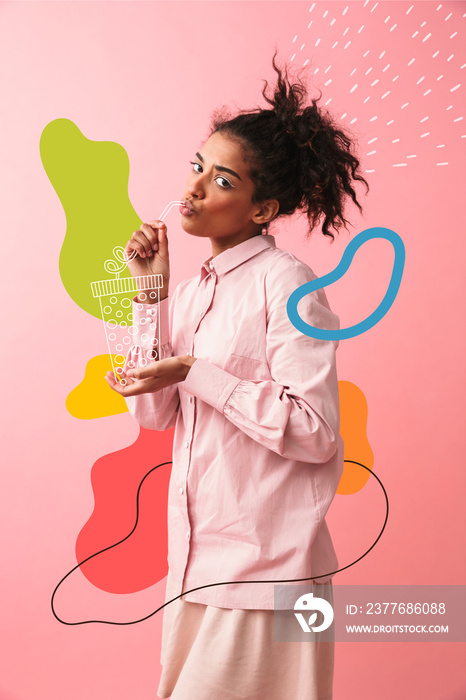 Beautiful young african woman posing isolated over pink wall background imagine that she drinking tea.