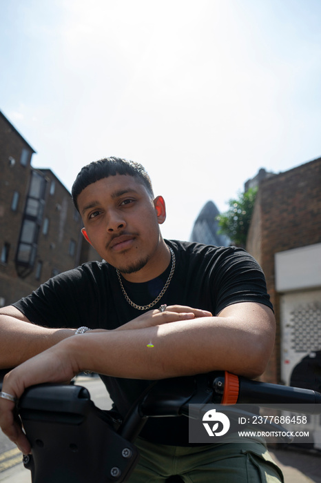 Man wearing black tshirt leaning on handlebar