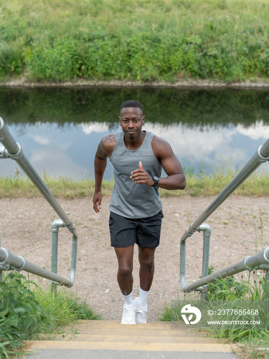 Man exercising outdoors running up stairs