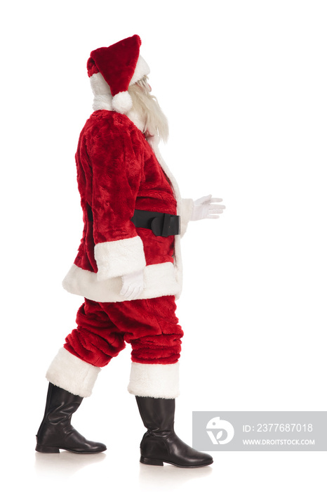 side view of fat merry santa claus walking