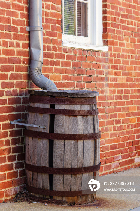 rain collection wooden barrel that is missing a stave