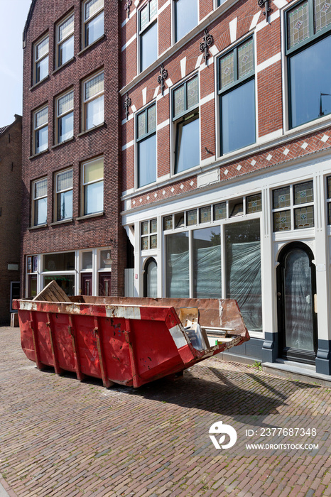 Red skip in a street in Rotterdam