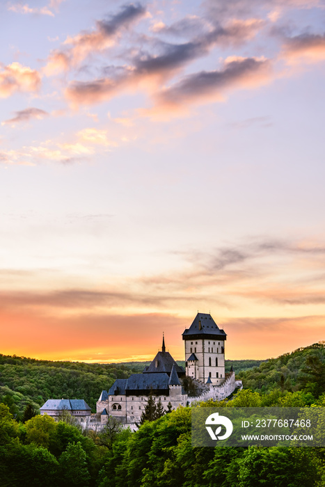 An orange twilight after sunset above the famous castle Karlstejn in Czech republic.