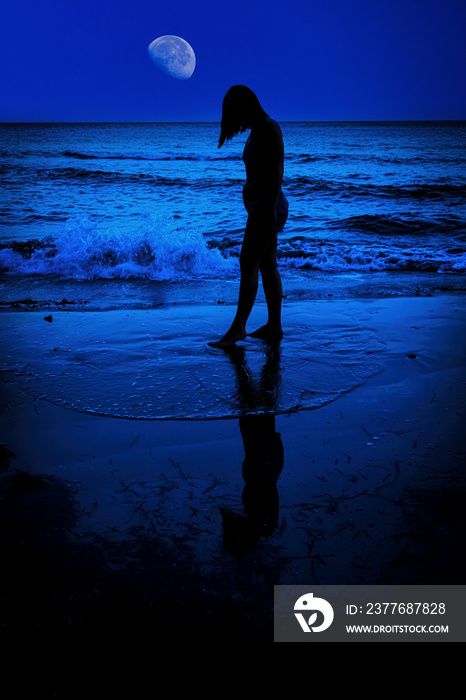 Sad girl under the moon at night on the sea