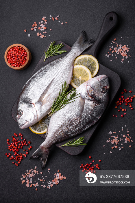 Fresh raw dorado fish with spices, herbs, salt and lemon