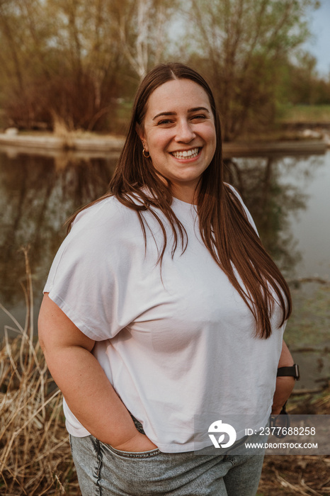 portrait of a plus size woman smiling and looking at camera