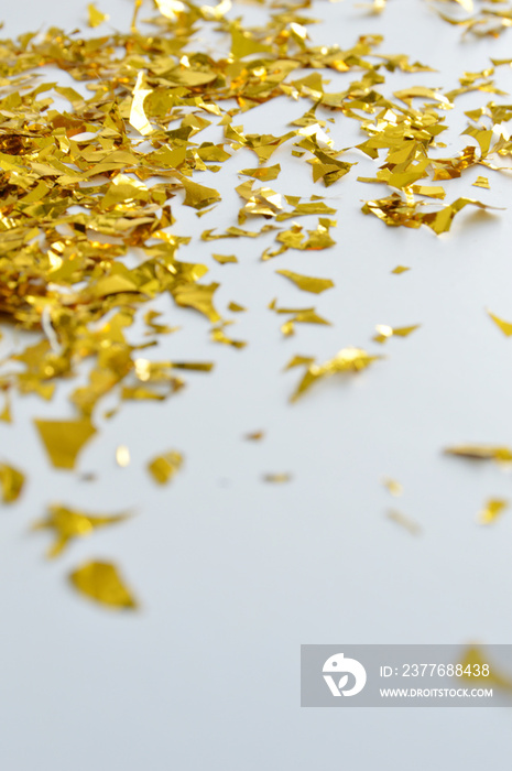 Close up photos of falling golden confetti on the floor