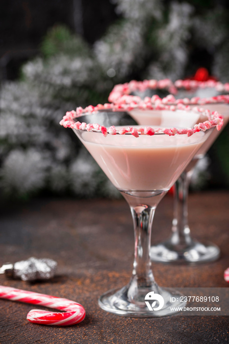 Pink peppermint martini with candy cane rim