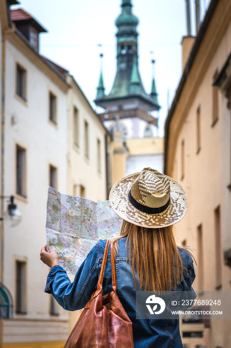 Woman tourist with map on the street. Tourism in Europe.