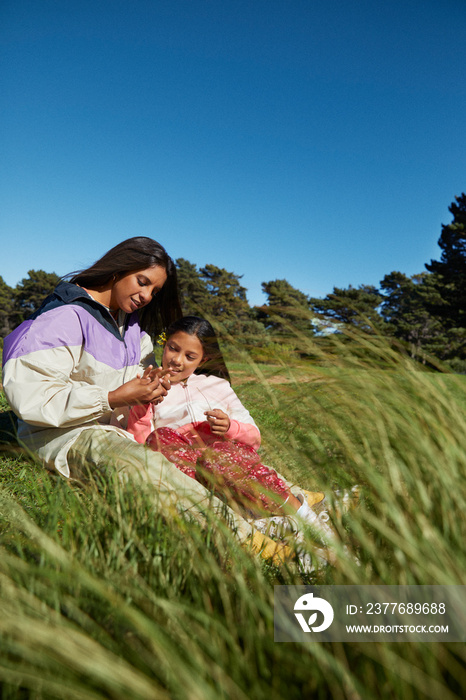 Mom and little girl having a sweet moment during family camping trip amongst nature