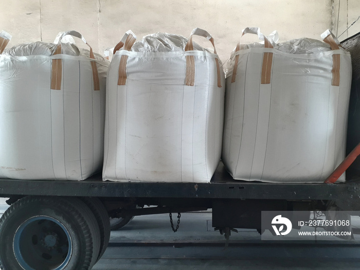 Large jumbo hemp sack White, packed with chemical fertilizer, rice, sugar, placed on a wooden pallet waiting to be delivered to the customer