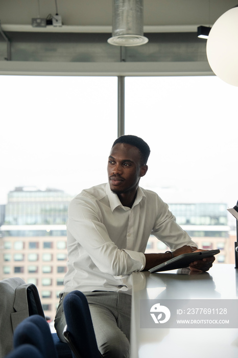 Young businessman using digital tablet in office