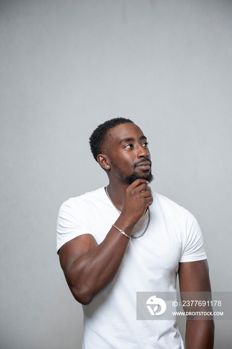 Man wearing white t-shirt and necklace