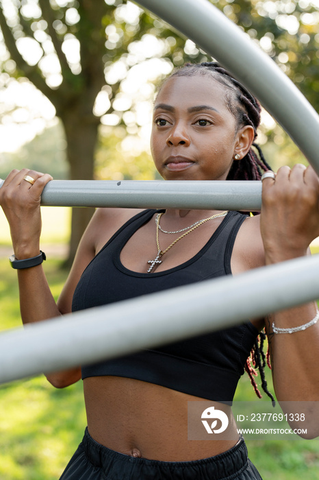 Young woman exercising in outdoor gym