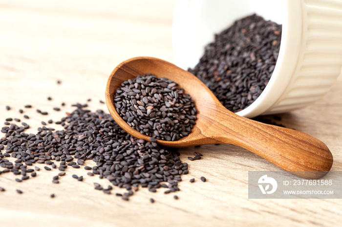 organic Black  sesame seeds in a wooden spoon ,healthy food for reductions in both systolic and diastolic blood pressure