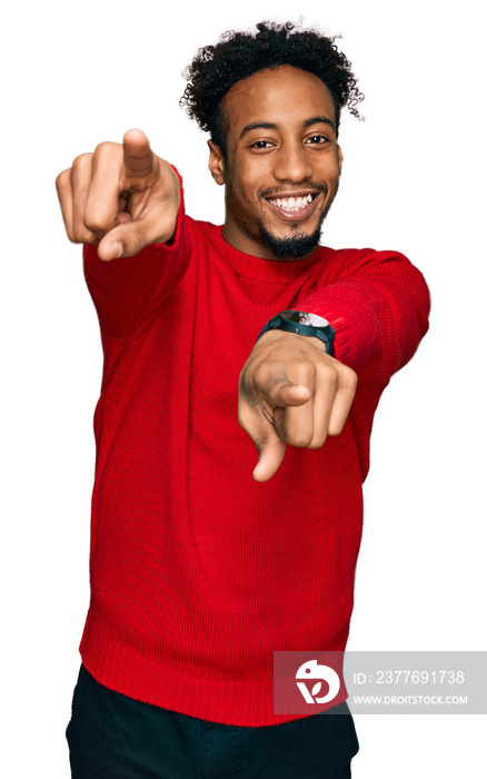 Young african american man with beard wearing casual winter sweater pointing to you and the camera with fingers, smiling positive and cheerful