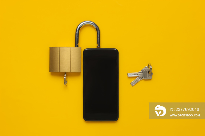 Protecting your smartphone’s personal data. Smartphone with keys lock on yellow background. Top view