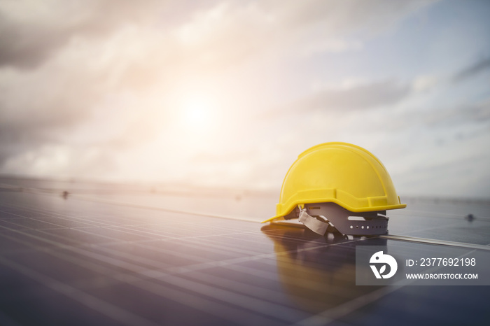 Yellow safety helmet on solar cell panel