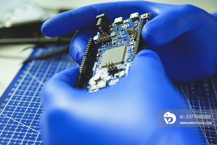 Cropped photo of man keeping microchip in arms