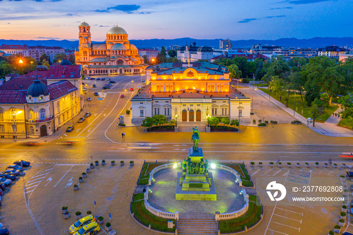 Night view of the National Assembly of the Republic of Bulgaria and Alexander Nevski cathedral in Sofia. Sign translates - Unity makes power