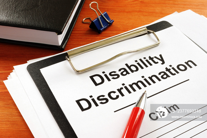 Disability Discrimination claim form and pen.