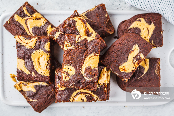 Vegan brownie with peanut butter on white background.