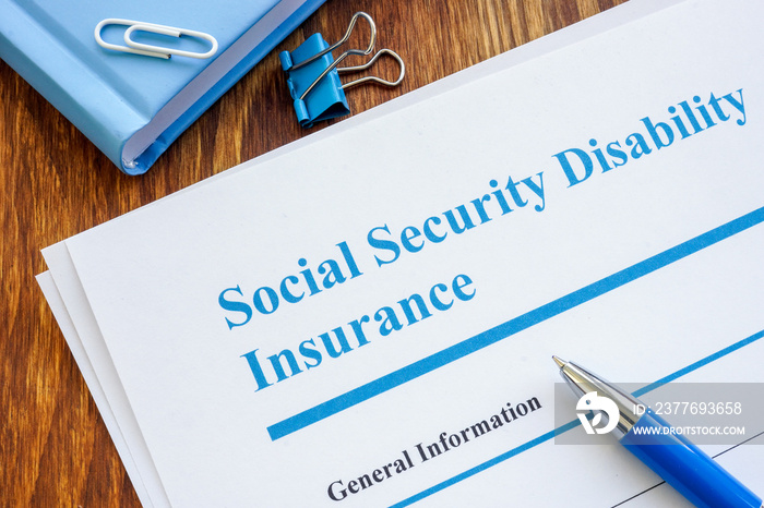 Social Security Disability Insurance SSDI application form and pen.