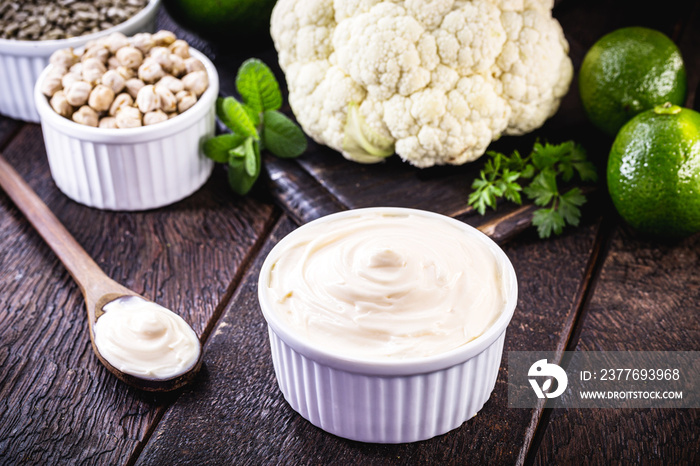 vegan mayonnaise, concept photo, mayonnaise made from vegetables without eggs or milk. Avocado cream, chickpeas, lemon, cabbage and sunflower seed.