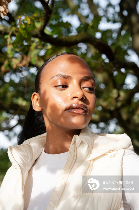 Portrait of woman in sunlight outdoors