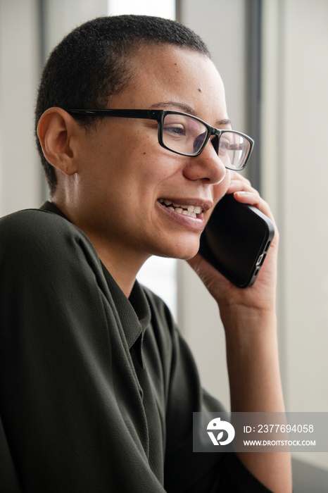 Woman wearing eyeglasses talking on phone