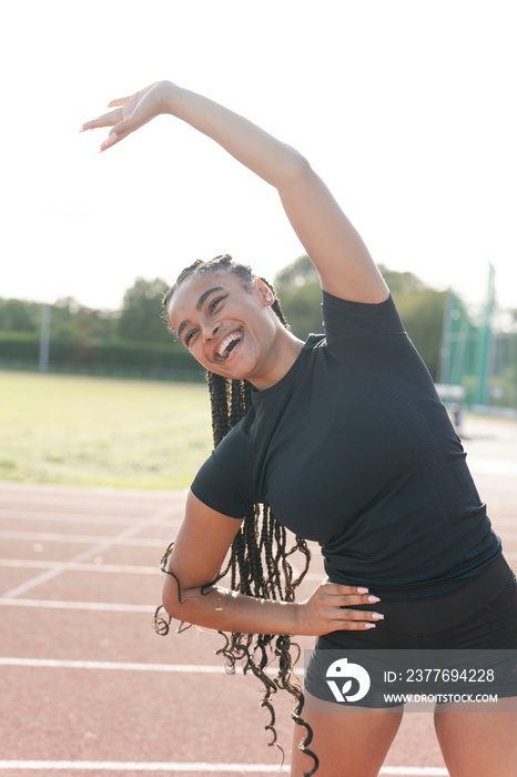 Female athlete exercising at sports track