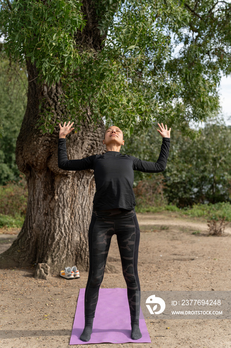 Woman practicing yoga in park