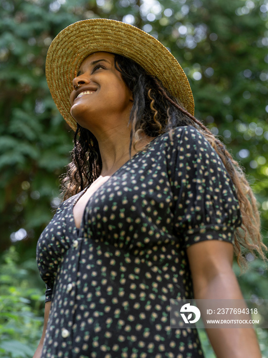 Portrait of smiling woman wearing straw hat