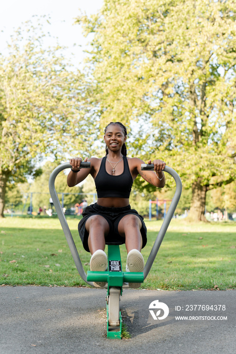 Young woman exercising in outdoor gym