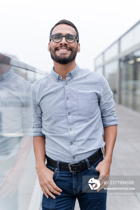 Office worker posing against office buildings