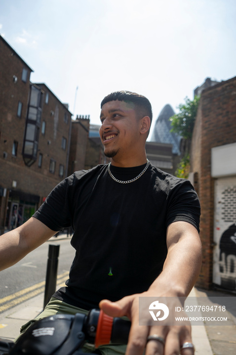 Smiling young man sitting on bike