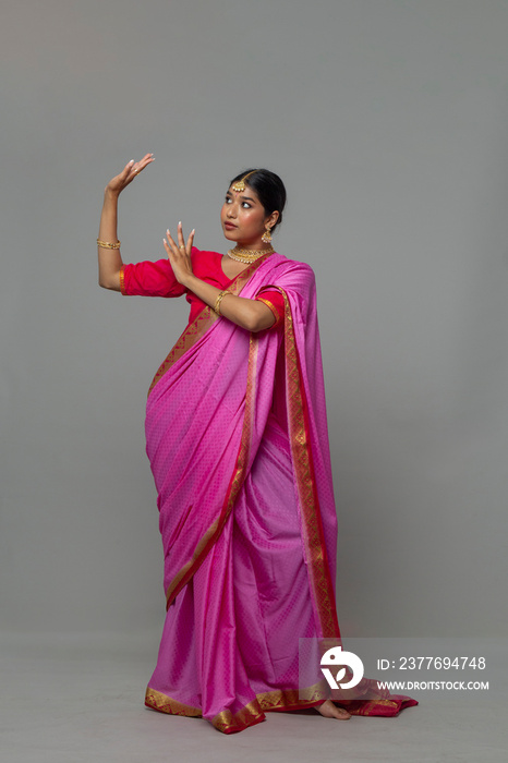 Studio portrait of woman wearing sari and gold jewelry