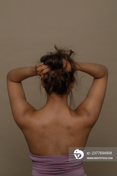 Rear view of woman with hands in hair