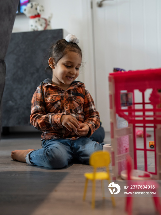 Boy (2-3) sitting on floor and playing