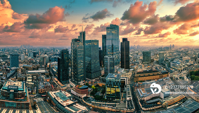 Aerial Drone View of London’s Financial Center at Sunset, a Glowing Skyline of Modernity and Prosperity