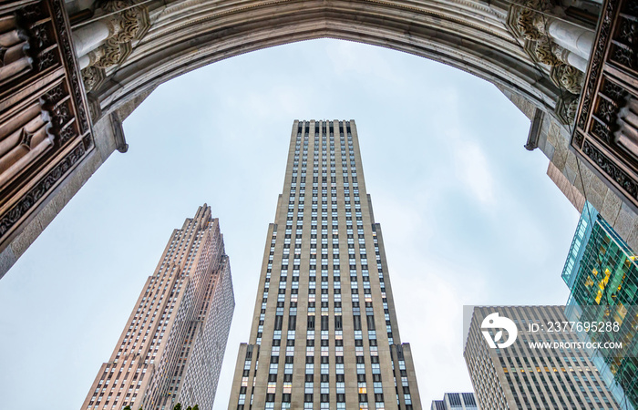 New York, Manhattan. High buildings view from below against blue sky background