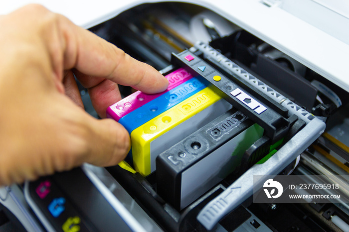 Technicians are install setup the ink cartridge or inkjet cartridge is a component of an inkjet printer