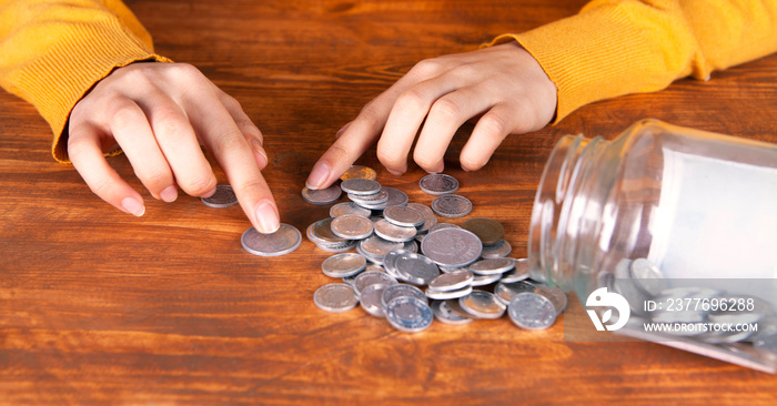 businesswoman with glass jar to save money