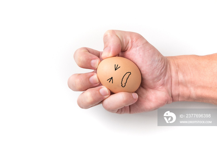 Hand squeeze egg with painful face on white background for emotional concept